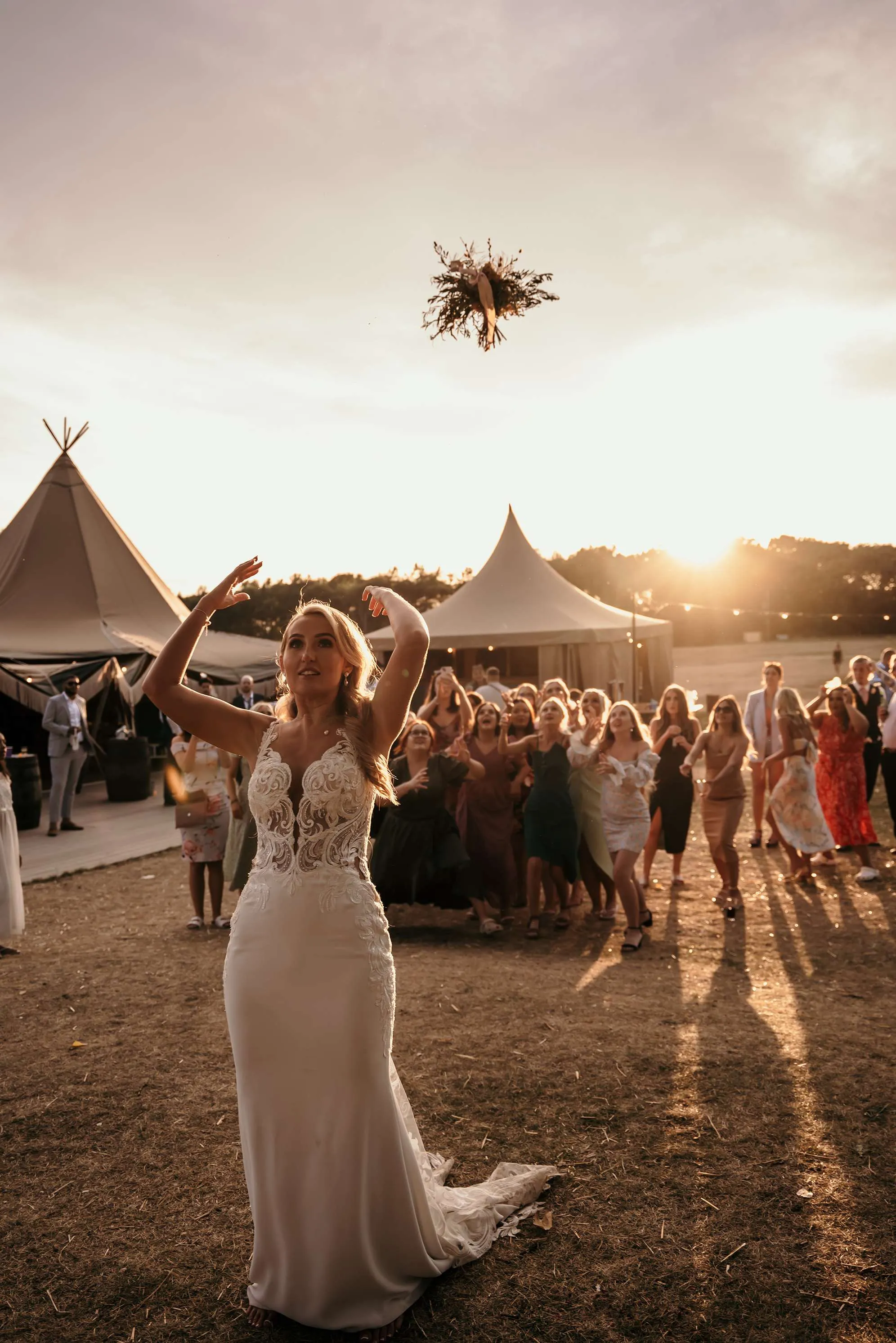 bride bouquet toss wedding photograph